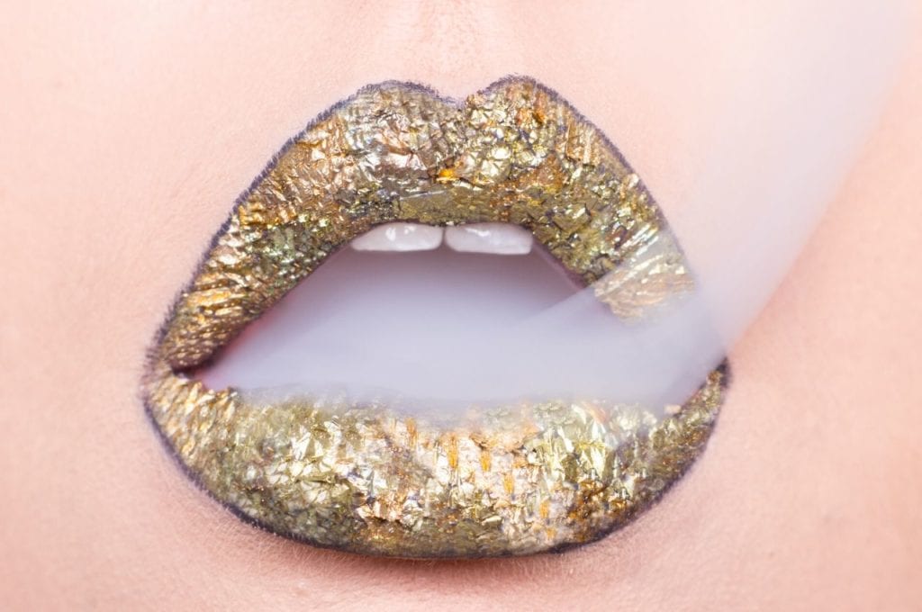 Cannabis Consumption Methods 101 | Cannabis 101 | My Supply Co. Smoke escapes gold painted lips.
