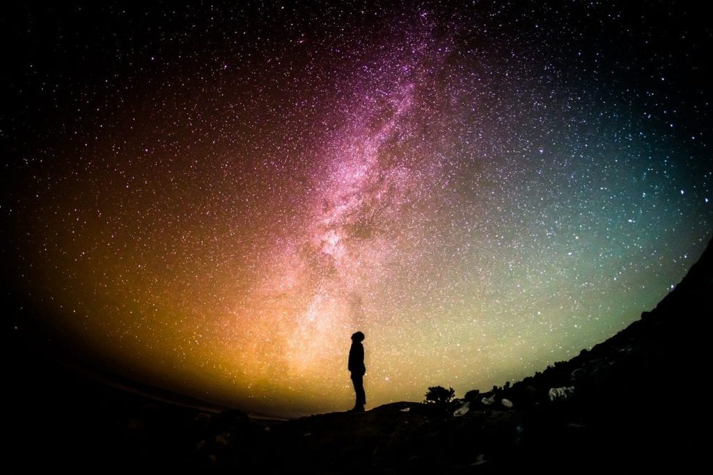 A man stares up at the milky way.