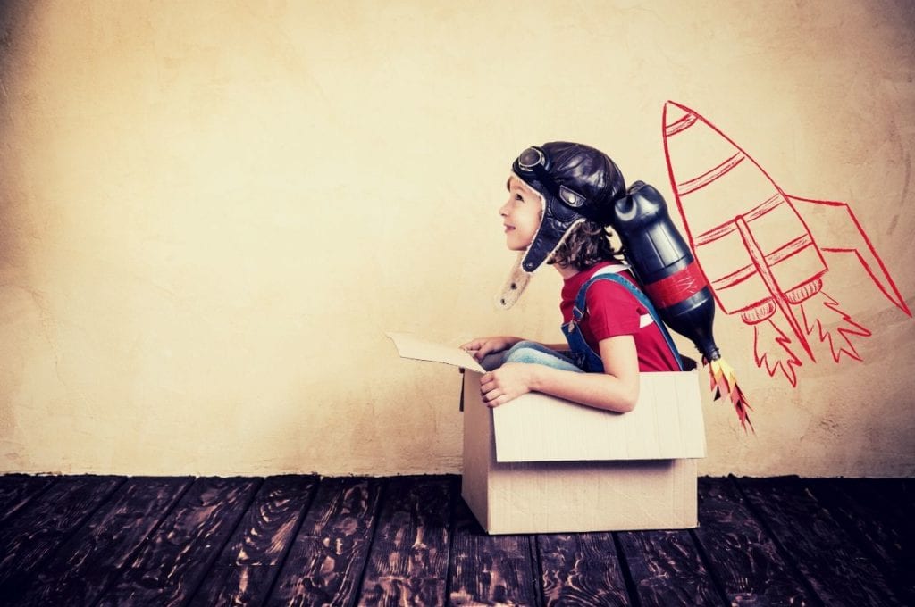 Empowered child dressed as superhero in box