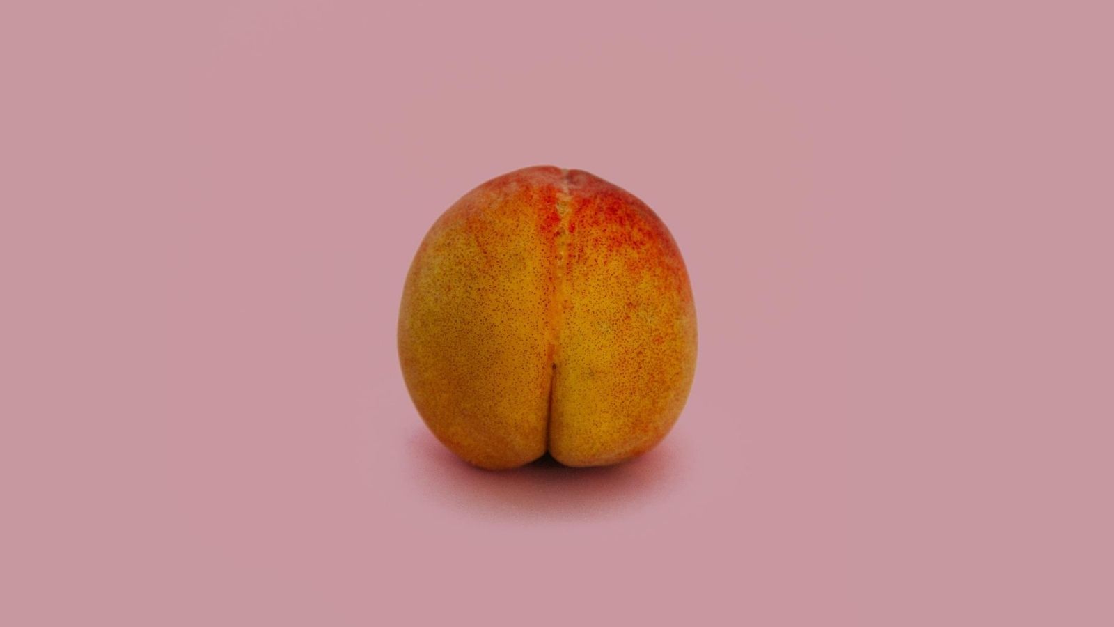 Conceptual image using a peach as a human butt