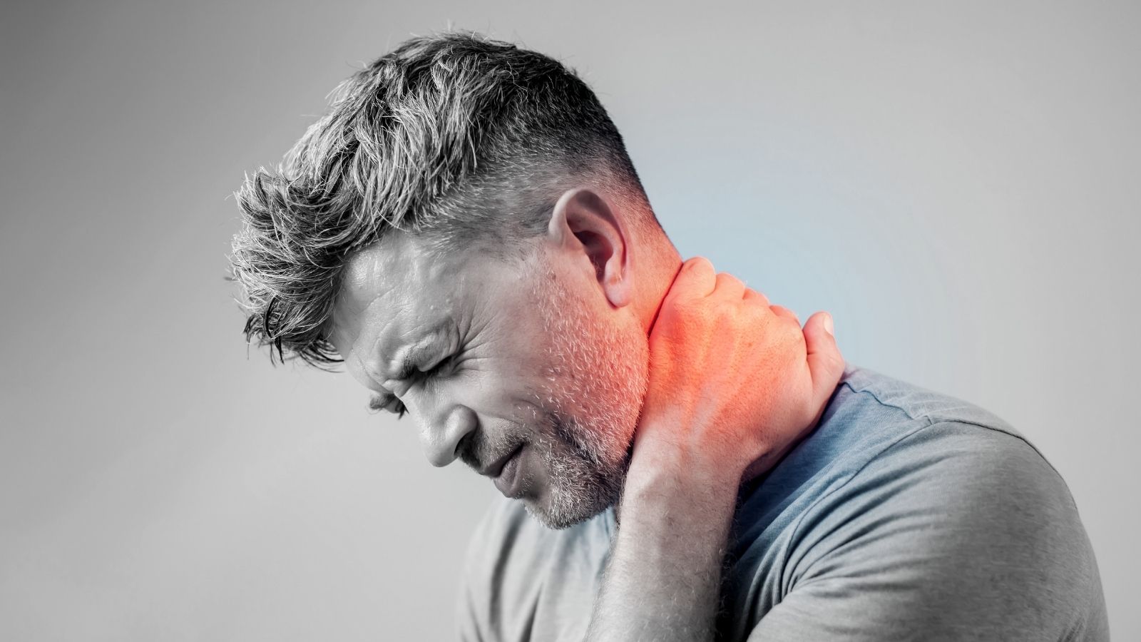 A man expresses inflammatory pain in his neck