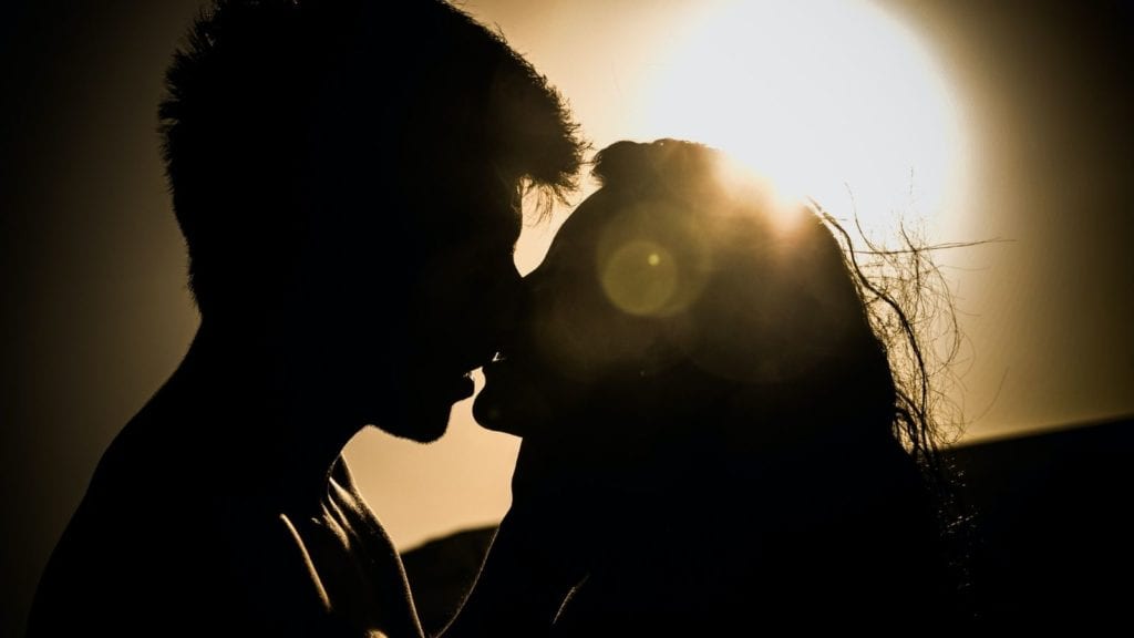 Romantic couple kissing silhouette