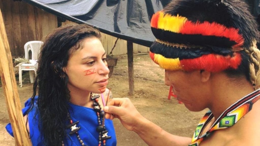 Sera receiving traditional face paint before a ceremony