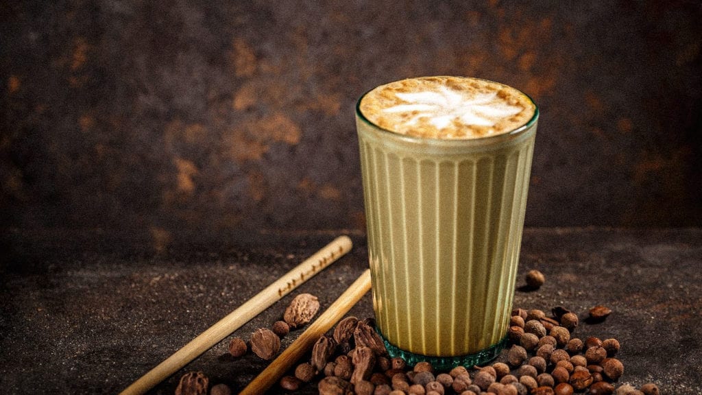 5 Cannabis-Infused Winter Warming Beverage Recipes | Recipes | My Supply Co. A glass of milky spiced chai surrounded by peppercorns