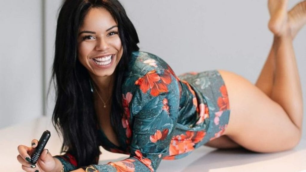 10 Influential Women in Cannabis — Happy International Women's Day | Culture | My Supply Co. A portrait of Antuanette Gomez lying down with a vape in her hand.