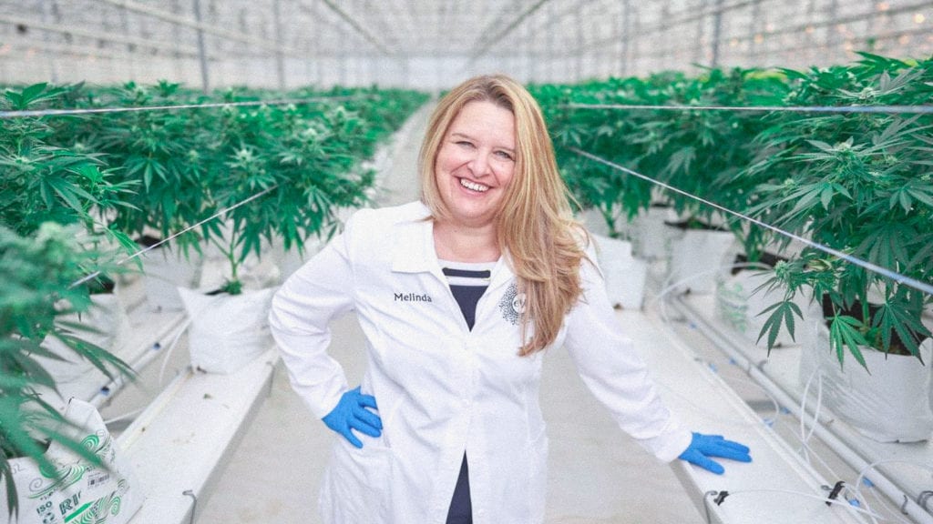 A photograph of Melinda Rombouts inside a cannabis cultivation facility.