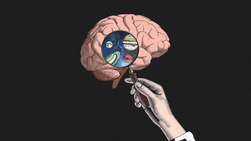 An illustration of a hand holding up a magnifying glass to a brain, and through the glass the universe is visible. A concept image of how magic mushrooms improve your brain's neuroplasticity.