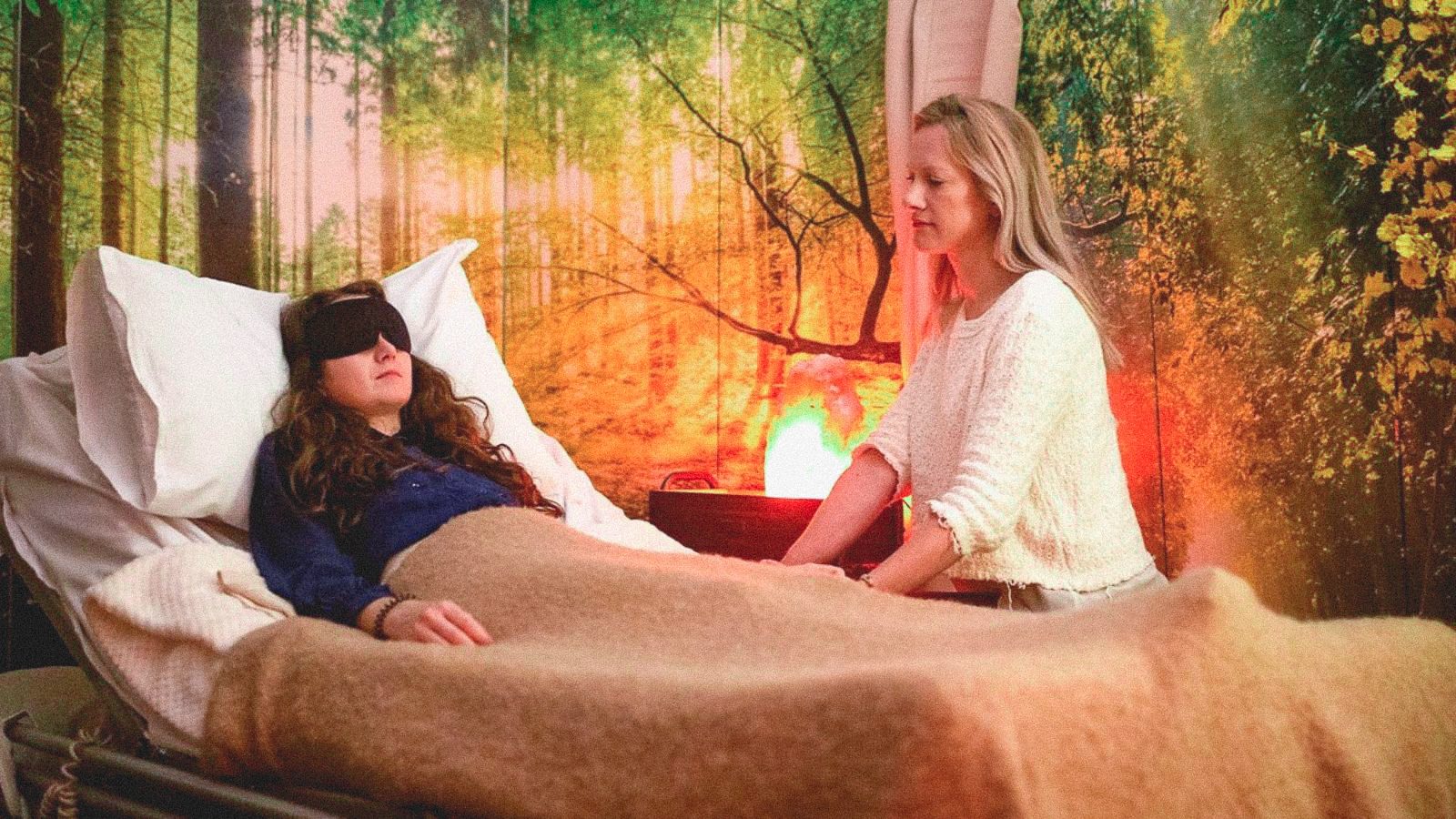 A photograph depicting a scene from the documentary, The Psychedelic Drug Trial, of a therapist assisting a woman through a psilocybin journey.