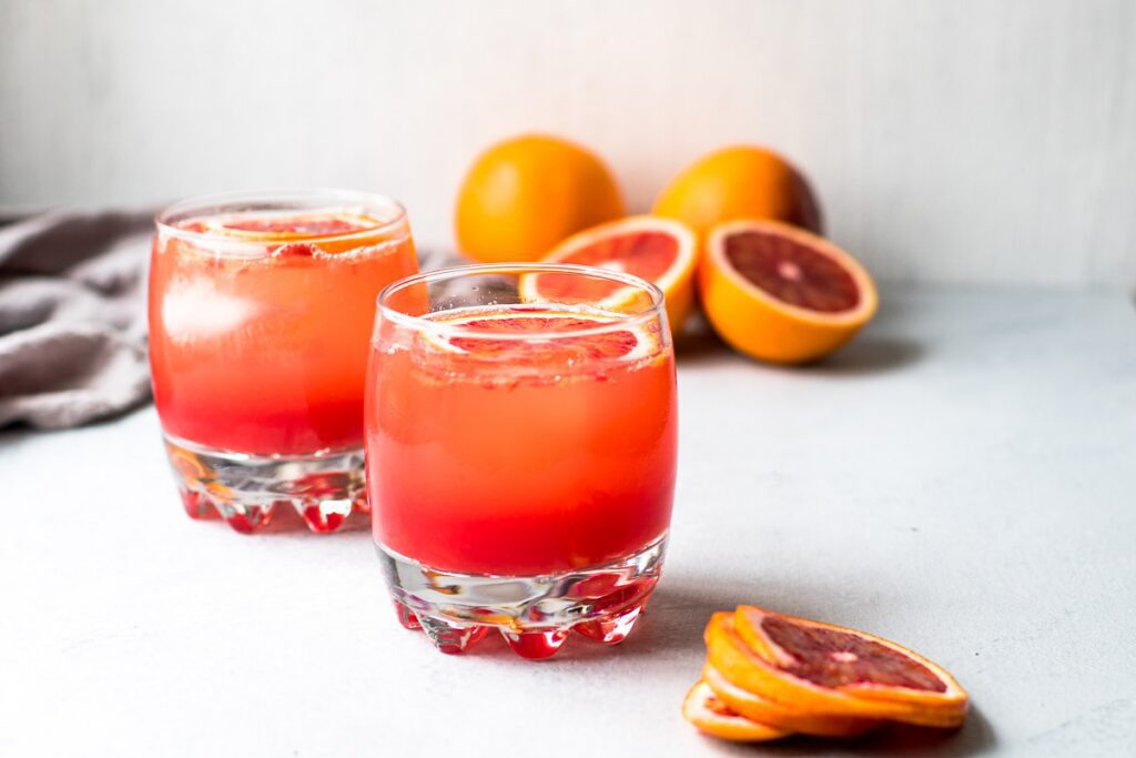 A photograph of two glasses of sparkling blood orange mocktail for an article on cannabis mocktail recipes