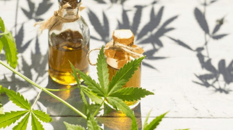 A photograph of home-made cannabis oils in small stoppered bottles with wax paper seals for an article on how to make spiced cannabis milk