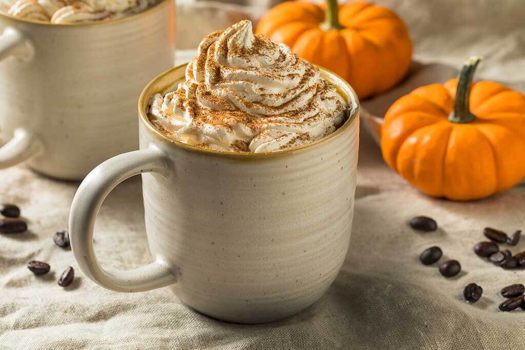 Cup of cannabis-infused pumpkin spiced latte for an article about 3 cannabis-infused halloween recipes