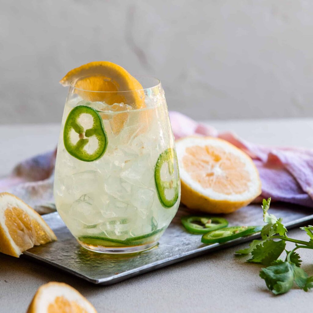 Photograph of an ice-cold cup of spicy coconut water lemonade for an article on cannabis mocktail recipes