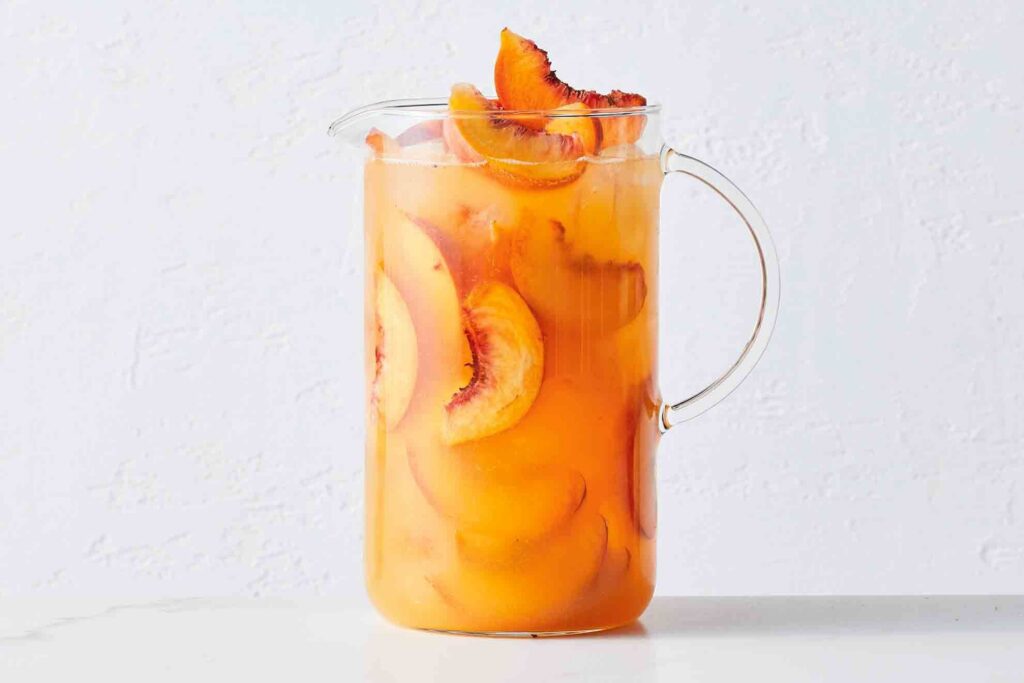 8 Cannabis Mocktail Recipes You Need to Try This Summer | Recipes | My Supply Co. Photograph of a pitcher of mango and peach kombucha bellini for an article on cannabis mocktail recipes
