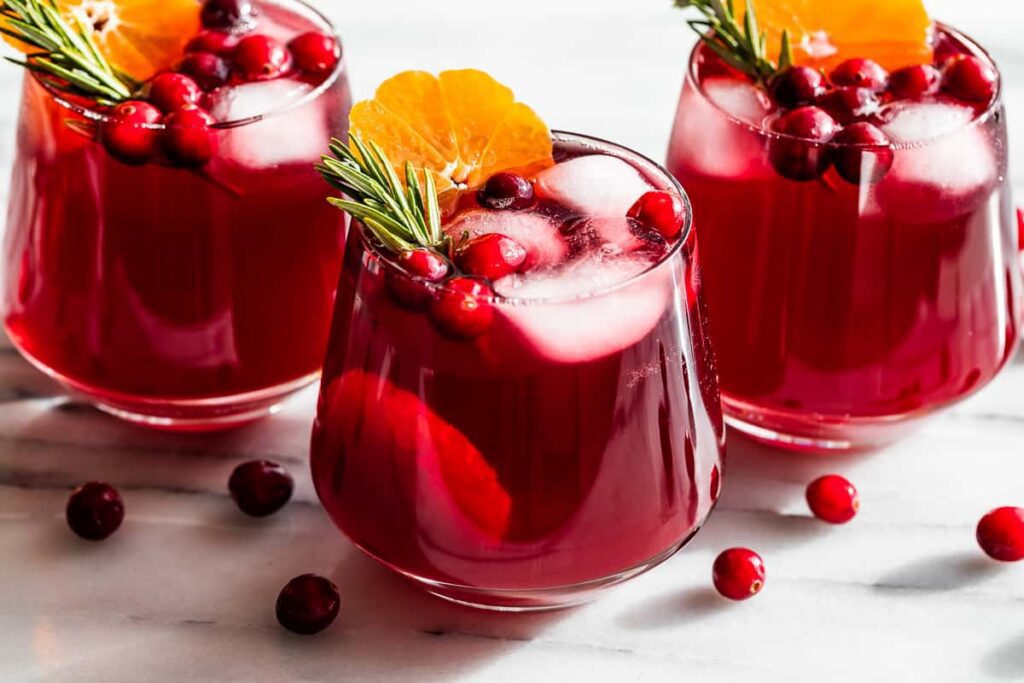 Photograph of three glasses of sparkling cranberry kombucha for an article on cannabis mocktail recipes